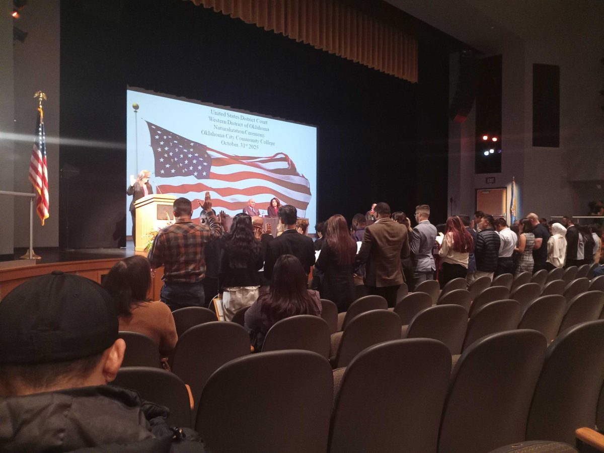New U.S. citizens take the Oath of Allegiance during a recent naturalization ceremony held inside OCCC's Visual and Performing Arts Center.