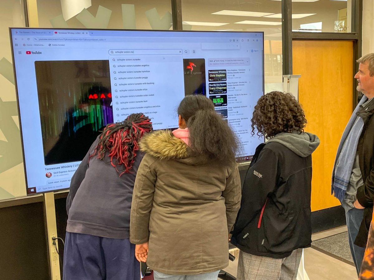 Students who attended the recent creativity workshop co-hosted by the Absolute and The Pioneer scroll through a catalogue of karaoke songs, searching for the perfect piece to sing next.
