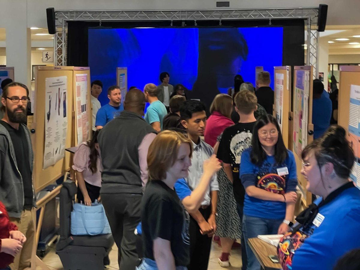 A crowd gathers around the many students presenting research projects during OCCC's first-ever Scholar's Day.