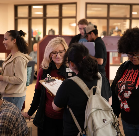 OCCC staff and students connect with smiles and clipboards during orientation, capturing the welcoming energy behind rising enrollment trends on campus.
