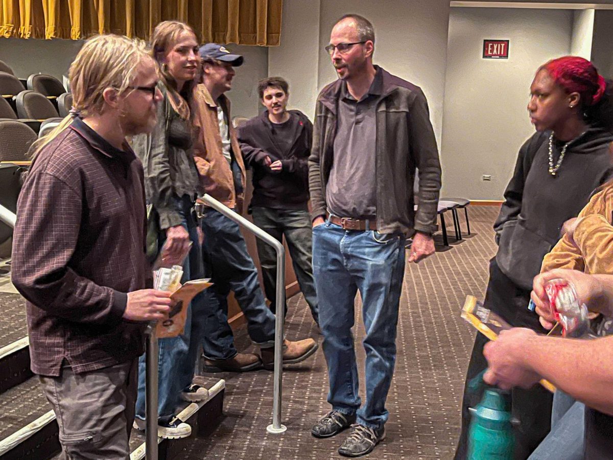 OCCC Professor of Digital Cinema Production Sean Lynch (center) speaks with students about the projects being showcased at a recent screening held earlier this semester.