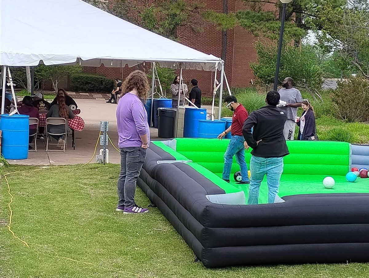 At the latest "Grill and Chill" event, students take part in a life-sized game of pool on the surface of a giant inflatable billiards table set up by the campus billiards club.