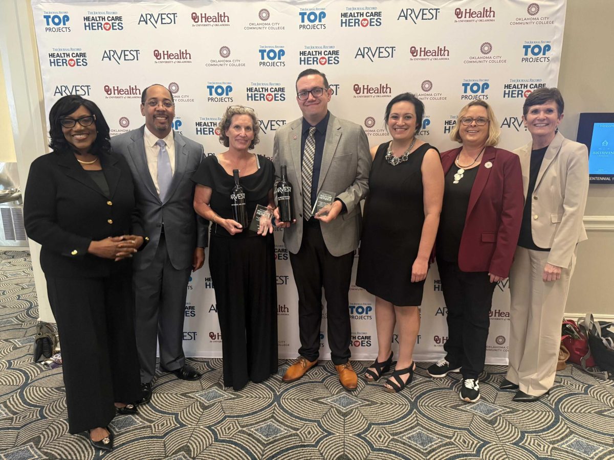 OCCC faculty and staff gather at the Skirvin Hilton to support Dr. Bryan Fulton (center) and Mary White, both faculty members in the health professions division, as they are recognized for their outstanding contributions to healthcare education.